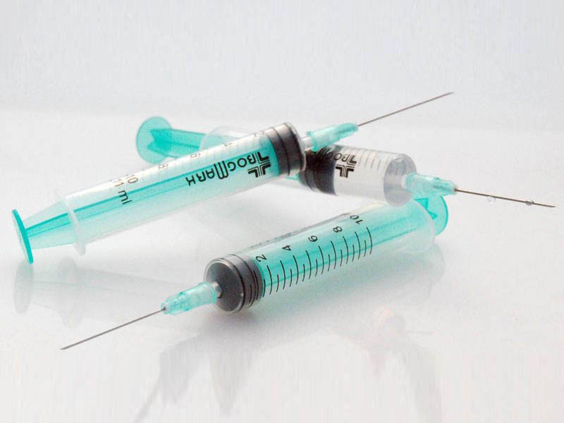 Methods for disinfecting needles and syringes